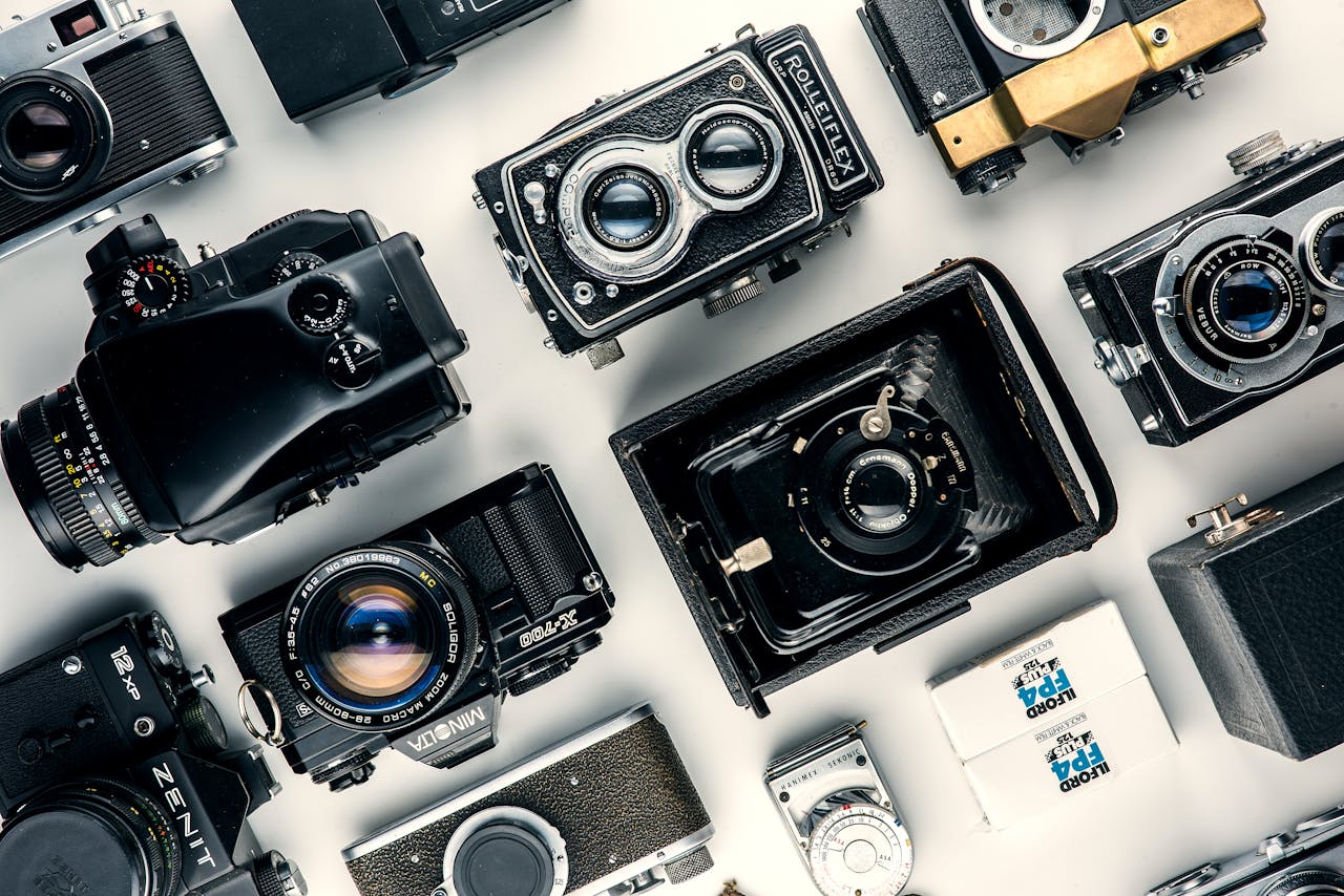 Flat lay of various vintage cameras showcasing classic design and retro charm.